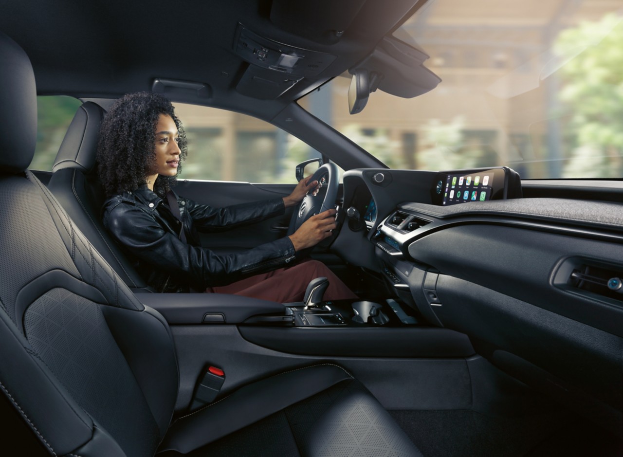 A woman driving a Lexus 300e 