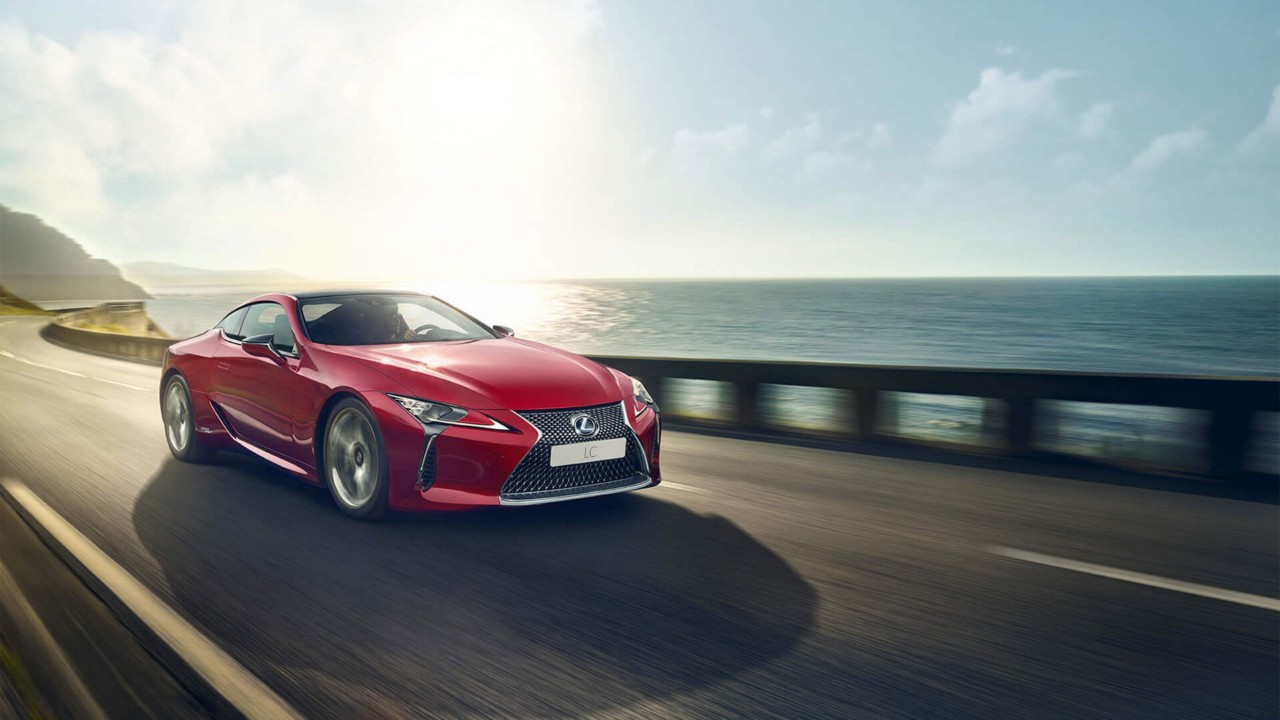 A Lexus LC driving on a coastal road 