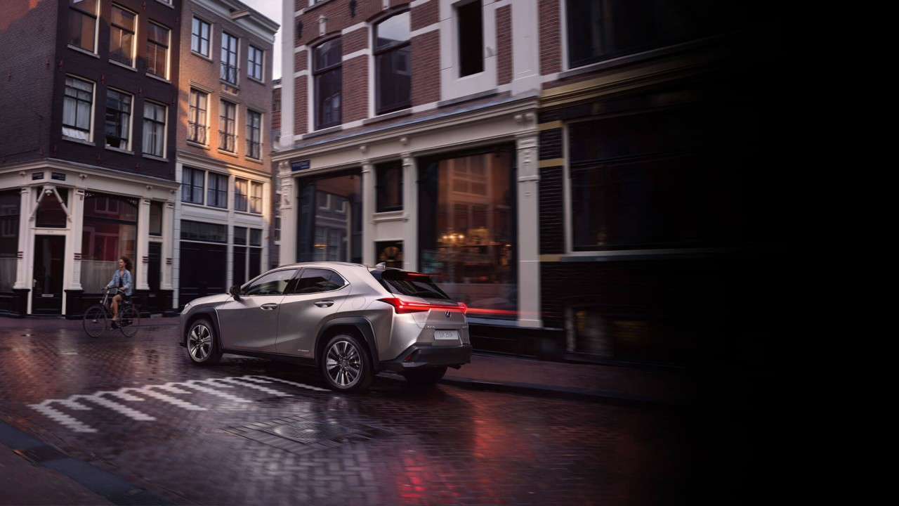 Lexus UX 250h driving in a town location 