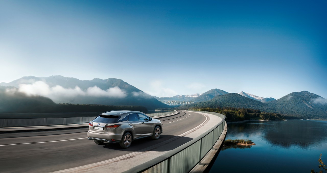 Lexus RX driving on a scenic road 