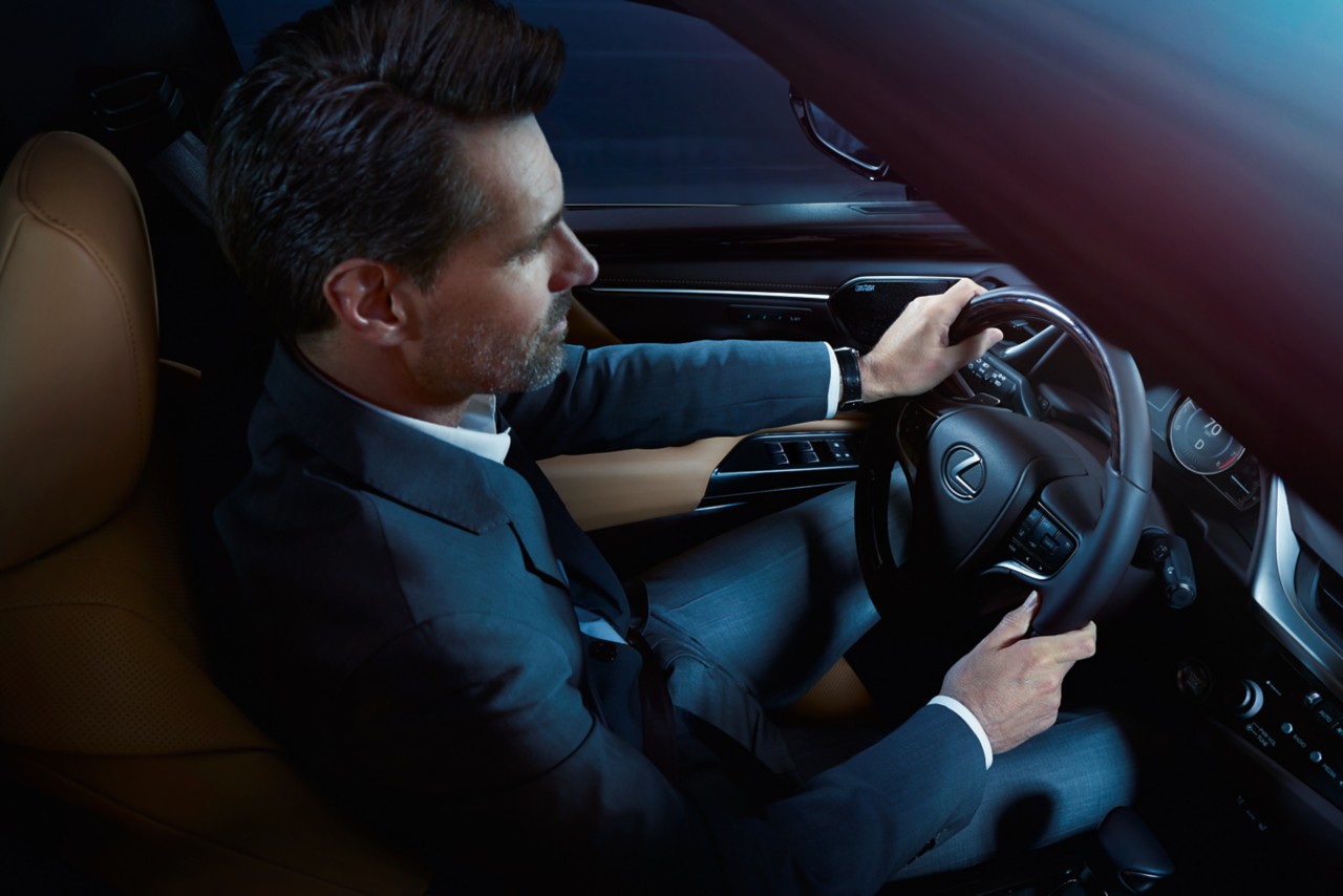 A man driving a Lexus 