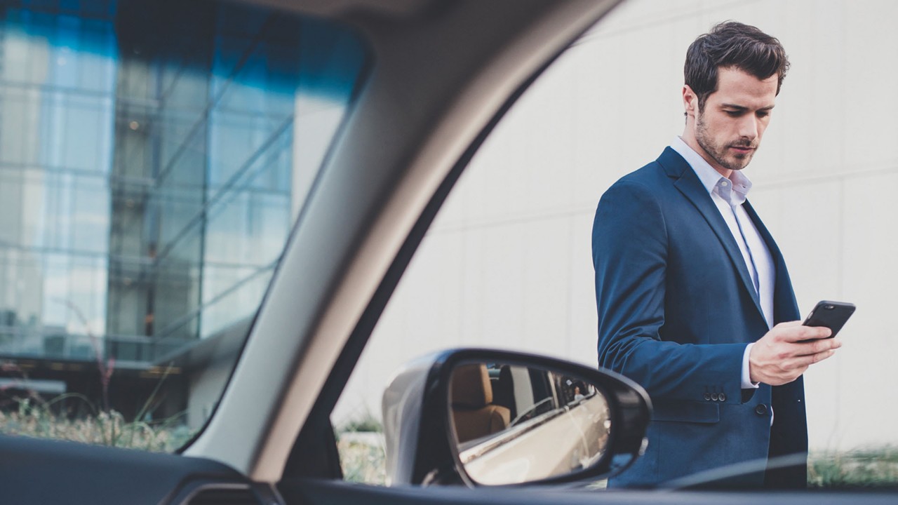 A man using his mobile phone to access the Lexus European Assistance programme