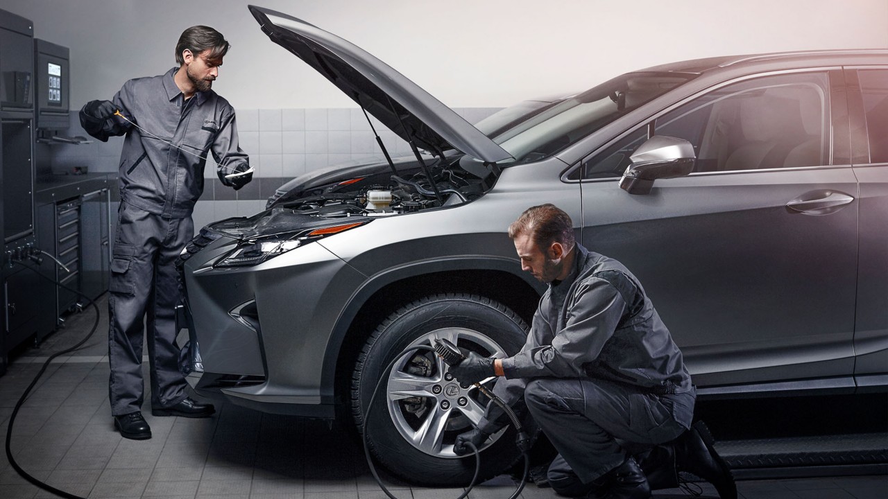 Two Lexus mechanics servicing a Lexus 