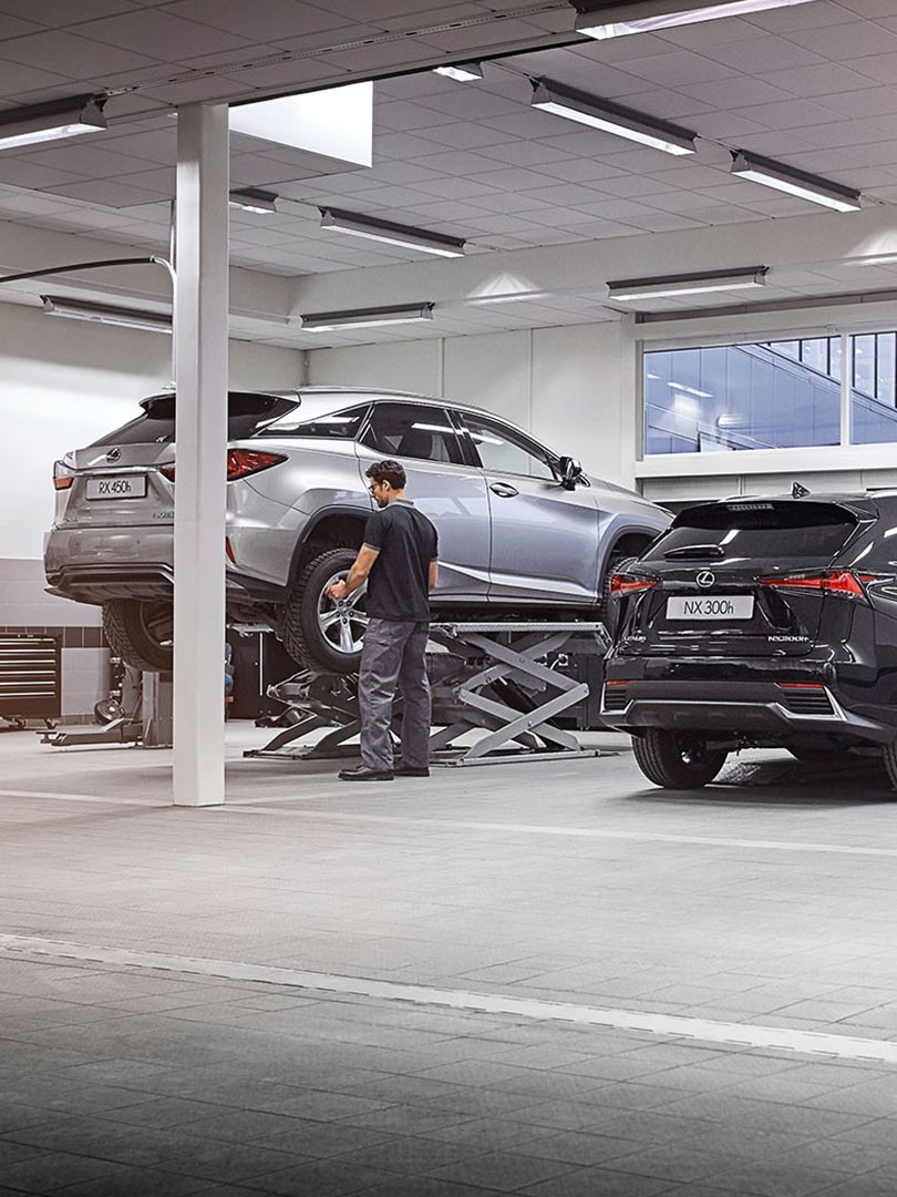 A Lexus RX 450h and NX 300h in a garage 