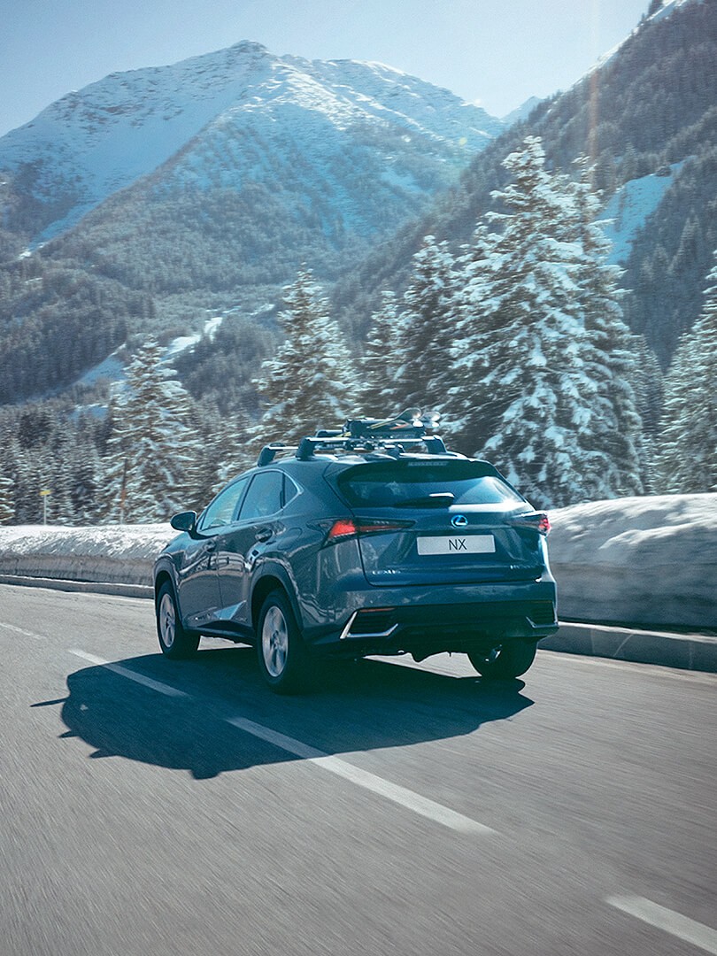 A Lexus NX driving in a mountainous environment 