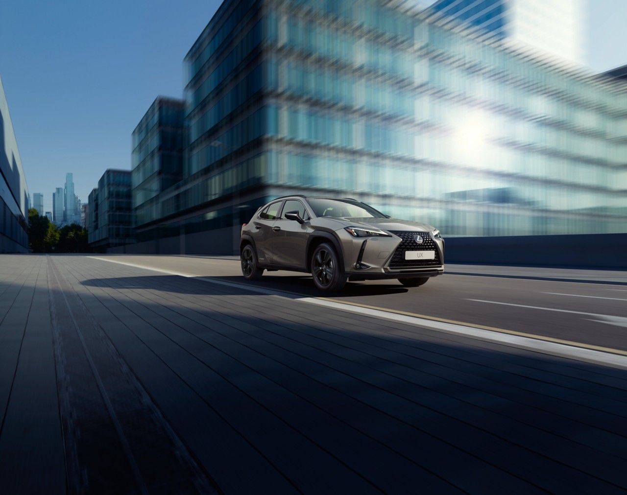A Lexus UX driving in a city 